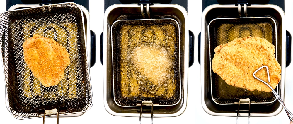 Breaded chicken filets in fryers