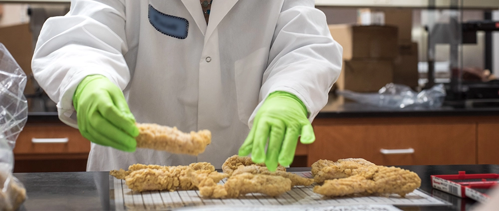 Brakebush R&D member working on perfecting chicken tenders