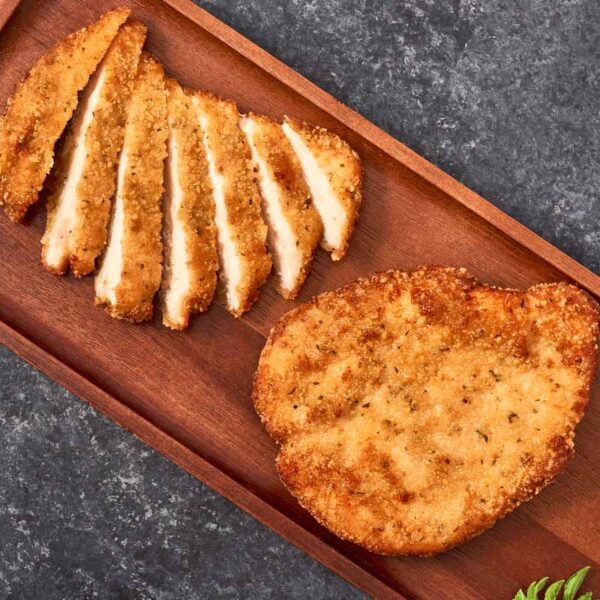 Chicken filets sliced on a cutting board