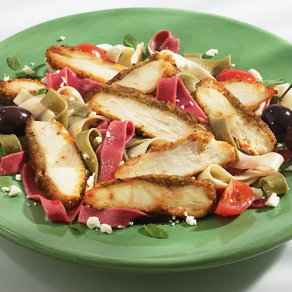 Pasta topped with sliced Tuscan-style chicken