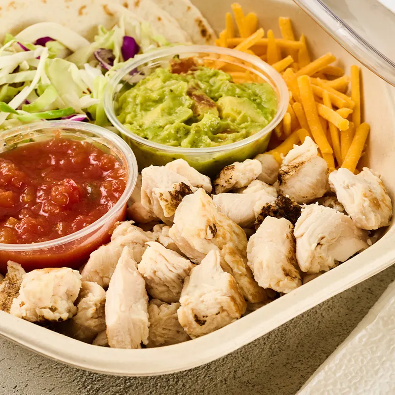 Flame-seared pulled chicken, cheese, lettuce, salsa, and guacamole in a taco kit