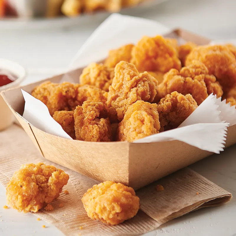 A boat tray full of popcorn chicken