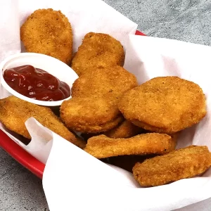 Chicken nuggets in a basket with sauce