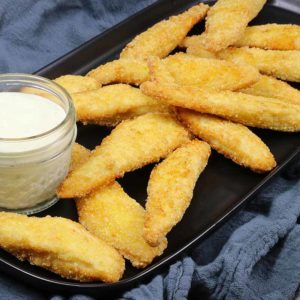 Gluten free chicken strips on a plate with ranch