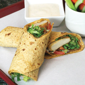 Chicken wrap with chicken nuggets, lettuce, tomato, and ranch