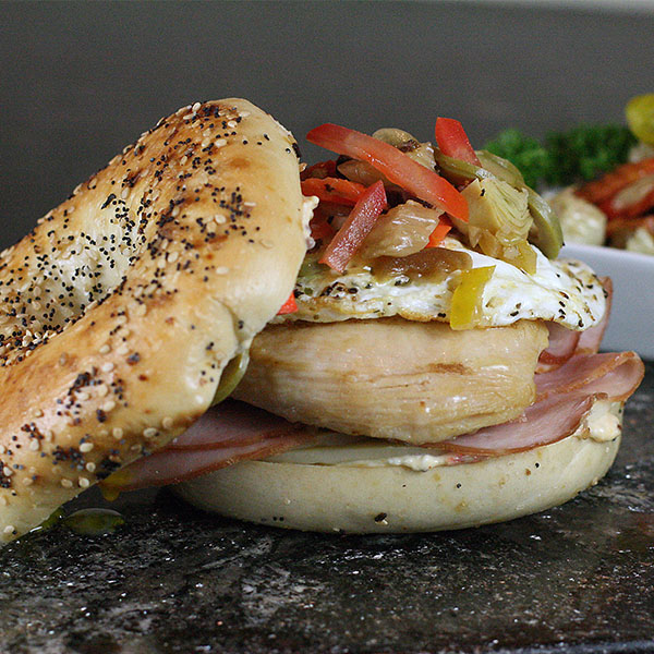 Bagel with ham, chicken, egg, and veggies