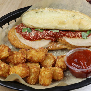 Chicken parm sandwich with a side of tator tots