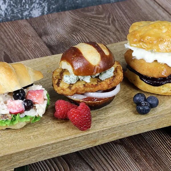 A flight of chicken sliders with red, white, and blue toppings