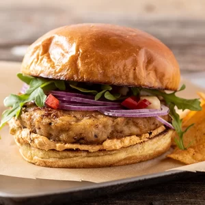 A chicken burger with harissa and veggies