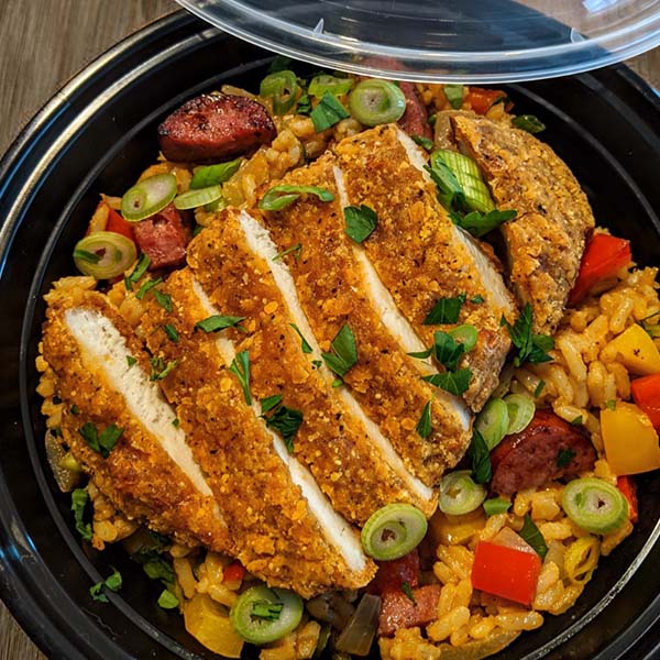 Sliced, breaded chicken filet atop Creole rice