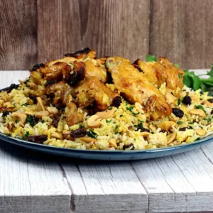 A plate of rice topped with chicken wings