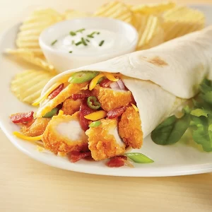 Plated wrap filled with breaded chicken, bacon, and cheese