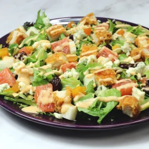 A chopped salad of lettuce, chicken, grapefruit, jicama, and a drizzle of miso ranch