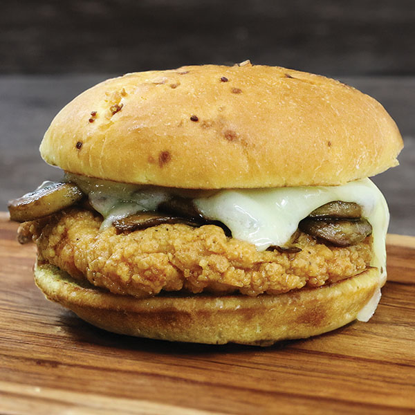 Chicken filet sandwich with mushrooms and melted Swiss cheese