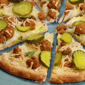 Pizza topped with dill pickle slices and popcorn chicken