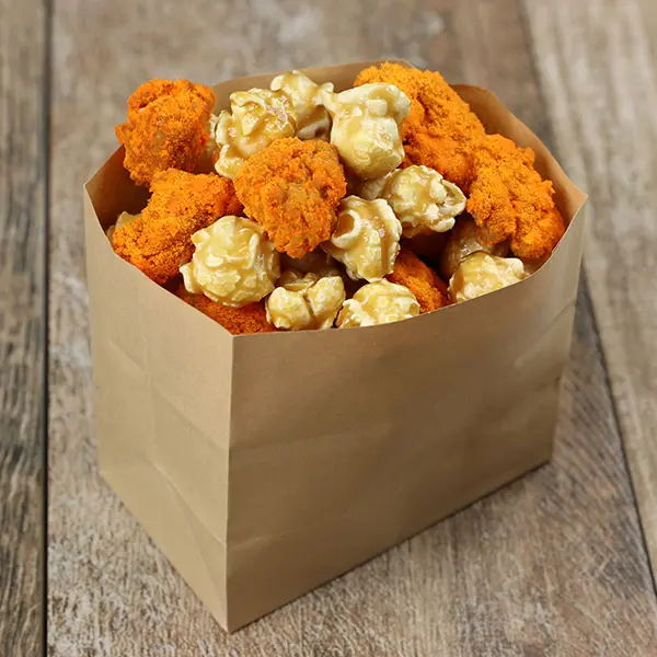 Small bag with caramel popcorn and cheese-dusted popcorn chicken