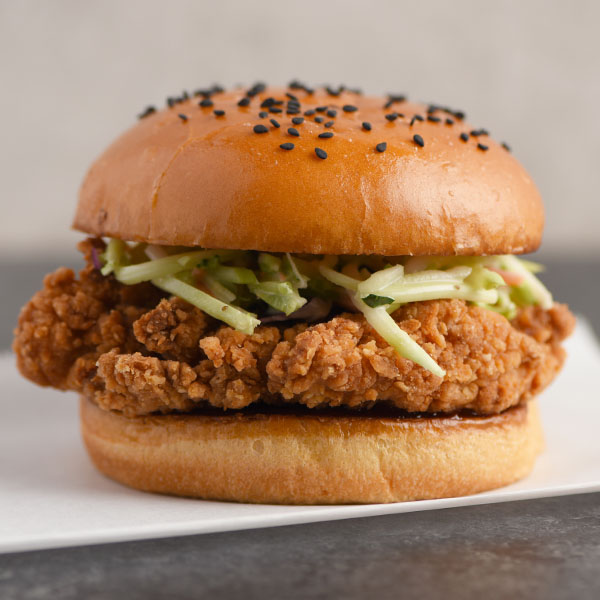 Spicy chicken filet sandwich topped with broccoli slaw