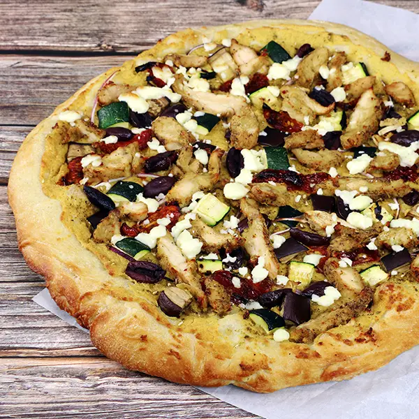 Za'atar Pizza with hummus, sliced chicken, olives, and zucchini