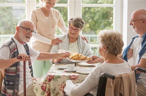 Friends dining in a senior living cafeteria