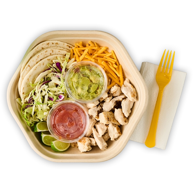 A meal kit with chicken, cheese, lettuce, salsa, guac, limes, and tortillas to make tacos